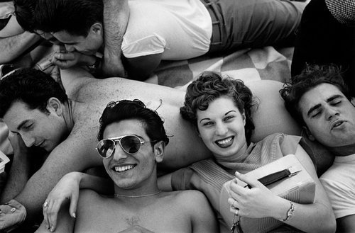 © Harold Feinstein, Several teenagers recline on a Coney Island beach, New York, 1949, © Harold Feinstein